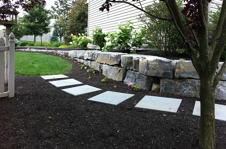Paver wall with stone walkway and landscape installed by Diebolt Landscape in Bird in Hand