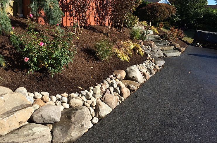 Hill with stone work and landscape designed and installed by Diebolt Landscape in Exeter PA